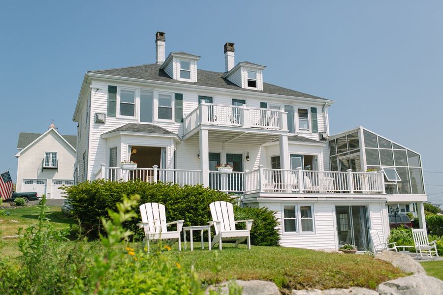 Historic Admiral's Quarters Inn with wraparound porches and lawn chairs