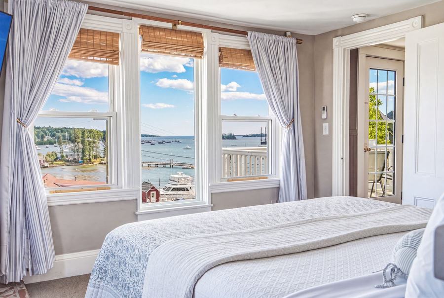 Bright guest room with harbor views and access to a private balcony