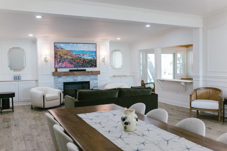 Shared living and dining room at Greenleaf Inn with dining table, comfortable seating, fireplace, and television, available to all guests.