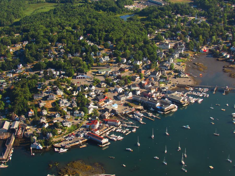 Boothbay Harbor, Maine, seen across the water with boats and the waterfront buildings in summer light